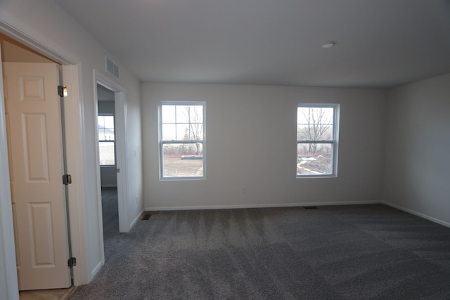 carpeted empty room with baseboards and visible vents