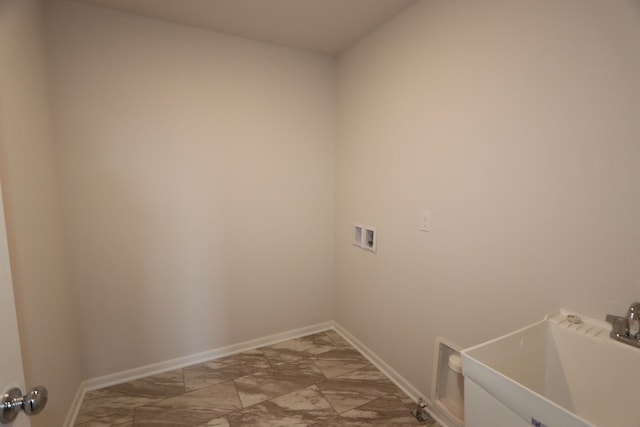 washroom with washer hookup, marble finish floor, a sink, baseboards, and laundry area