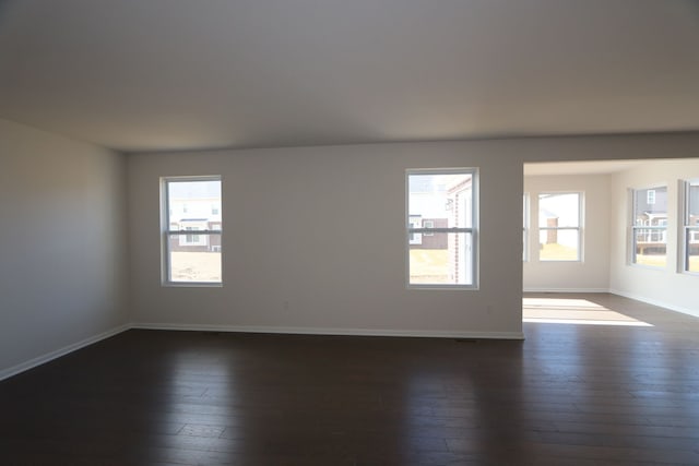 unfurnished room featuring dark wood finished floors and baseboards