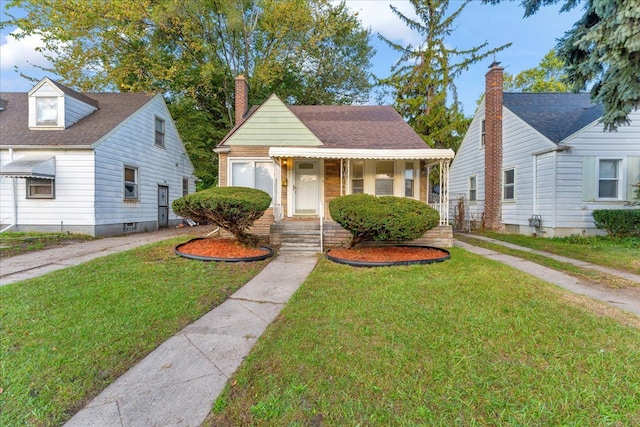 bungalow-style house with covered porch and a front lawn