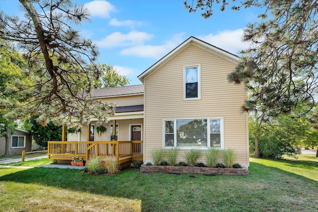 front of property with covered porch and a front lawn