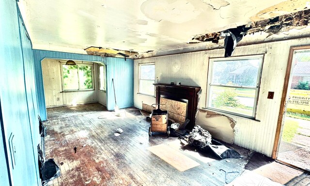 19685 Teppert St, Detroit, MI 48234 - living area with hardwood / wood-style floors, plenty of natural light, and wooden walls