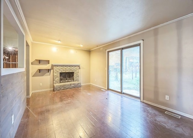 unfurnished living room with hardwood / wood-style flooring, ornamental molding, and a fireplace