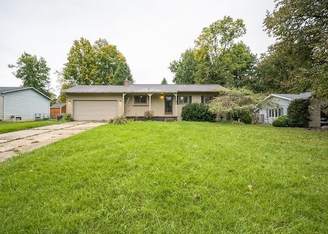 single story home with a garage and a front lawn