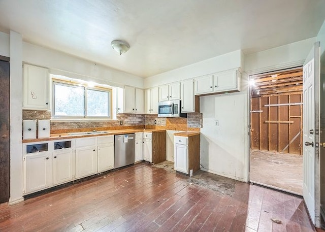 7178 Sherwood Ln, Davison, MI 48423 - kitchen with a sink, backsplash, white cabinets, appliances with stainless steel finishes, and dark wood-style floors