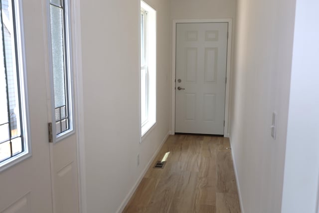 corridor with light hardwood / wood-style flooring