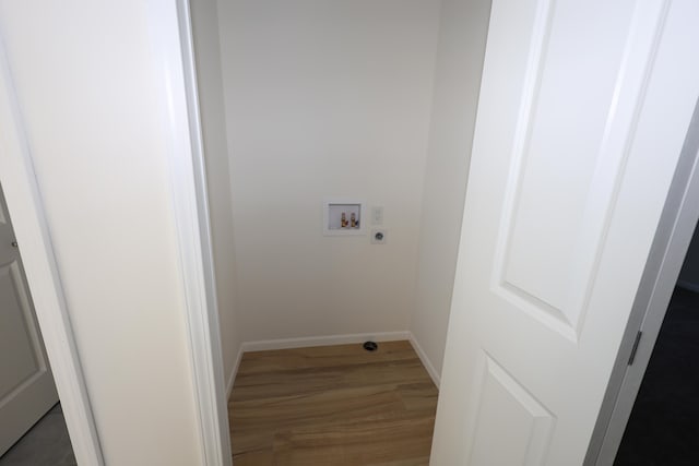 washroom with dark wood-type flooring, hookup for an electric dryer, and washer hookup