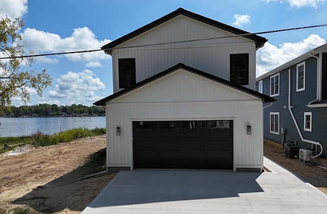 garage with cooling unit and a water view