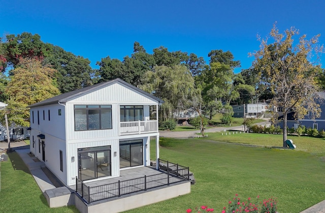 back of property featuring a lawn and a balcony