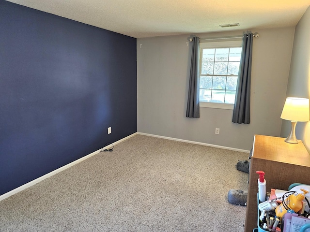 interior space featuring a textured ceiling and carpet floors