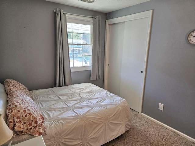 bedroom with a closet and carpet floors