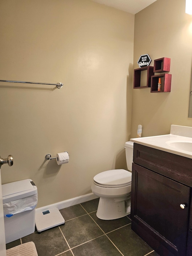 bathroom featuring tile patterned flooring, vanity, and toilet