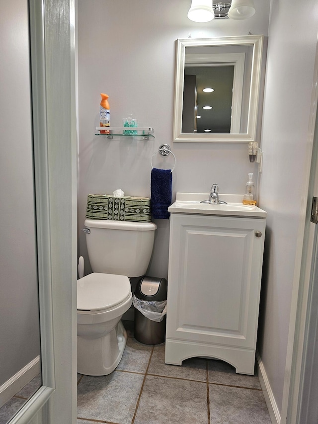 bathroom with tile patterned flooring, vanity, and toilet