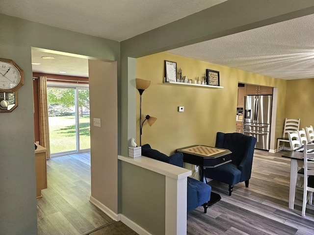 interior space with wood-type flooring and a textured ceiling