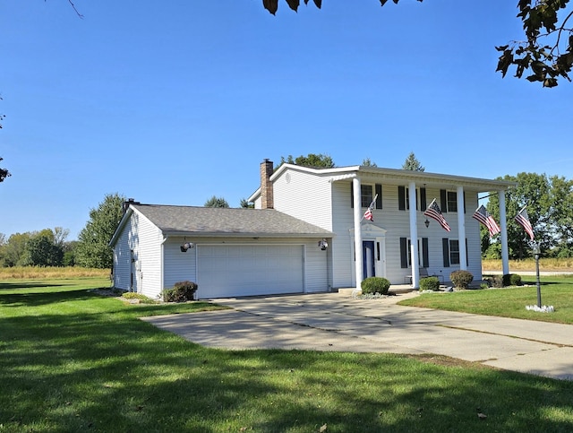 view of front of house featuring a garage and a front lawn