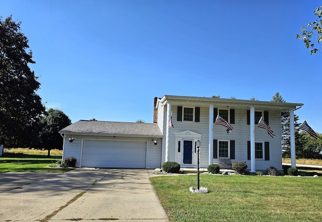 view of front of home featuring a garage and a front lawn