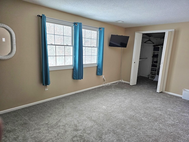 unfurnished bedroom featuring a closet, carpet floors, and a textured ceiling