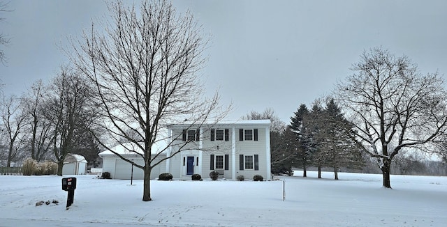 colonial inspired home featuring an outbuilding and a garage