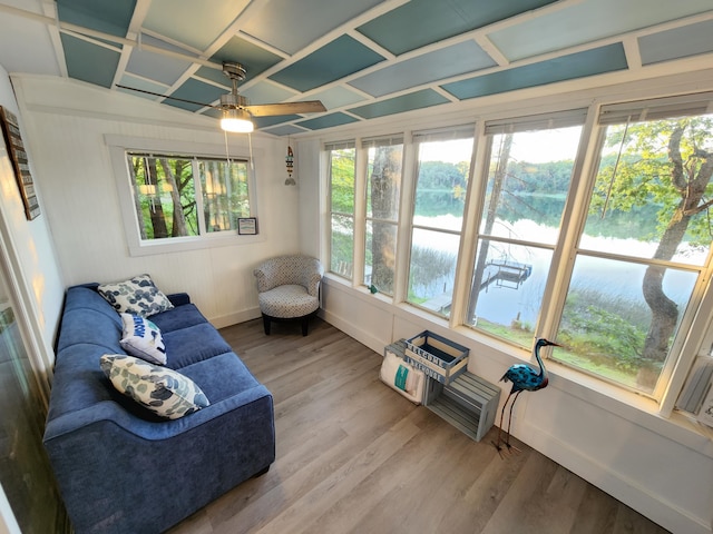 sunroom featuring a water view, ceiling fan, and coffered ceiling