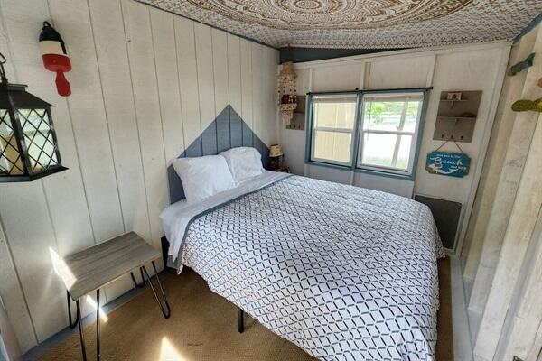 bedroom with wood walls