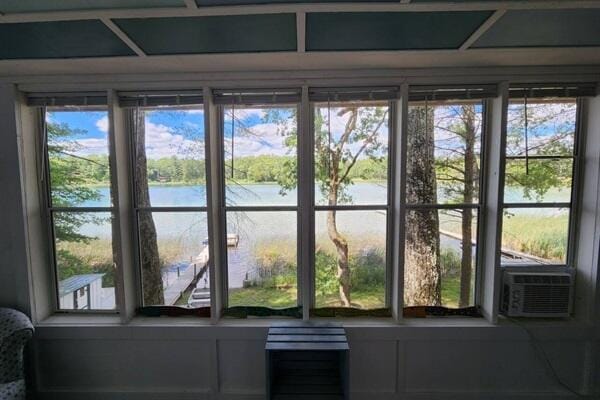 doorway featuring cooling unit and a water view