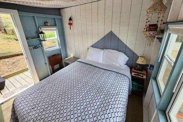 bedroom with wooden walls