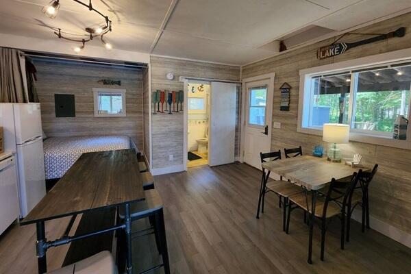 dining room with hardwood / wood-style flooring and wooden walls