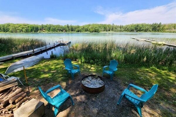 view of yard with a boat dock and a water view