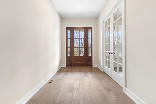 entryway featuring french doors and light wood-type flooring