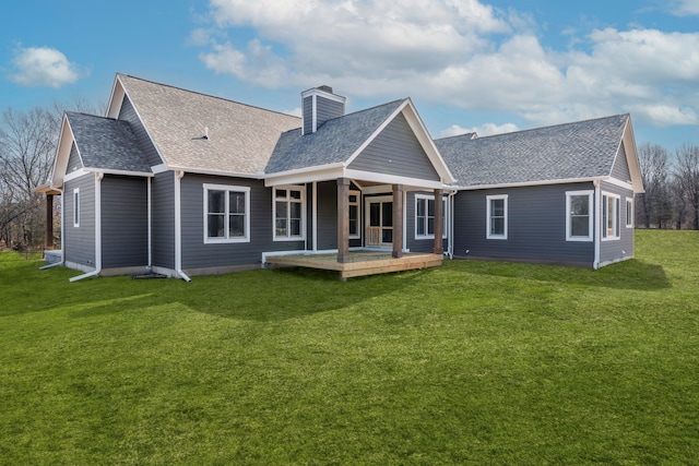 back of house with a lawn and a wooden deck