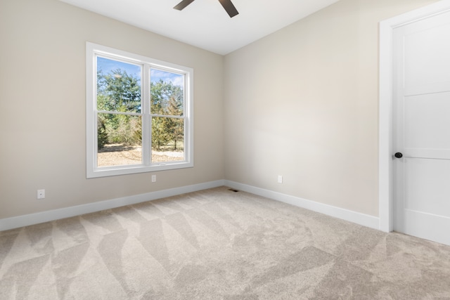 spare room featuring light carpet and ceiling fan