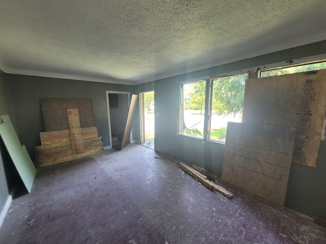 unfurnished room with a textured ceiling