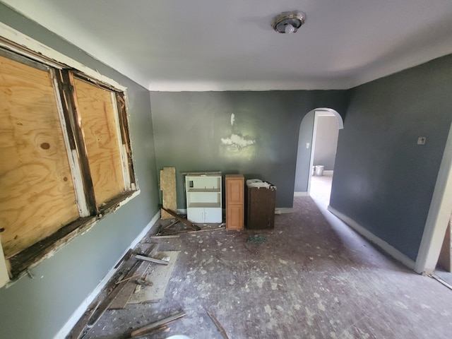 15379 Dolphin St, Detroit, MI 48223 - spare room with arched walkways, baseboards, and heating unit