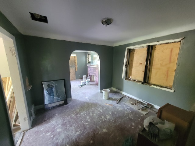 15379 Dolphin St, Detroit, MI 48223 - unfurnished living room featuring arched walkways and baseboards