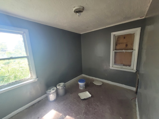 15379 Dolphin St, Detroit, MI 48223 - spare room with a textured ceiling and baseboards