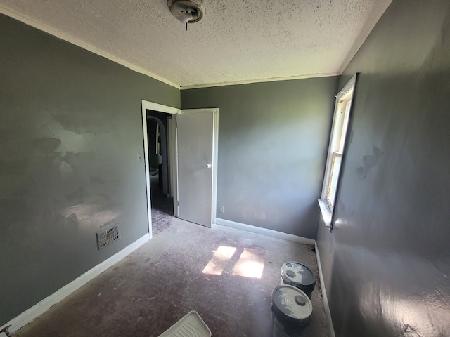 spare room with a textured ceiling