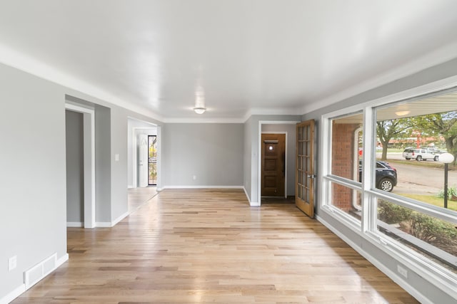 empty room featuring light hardwood / wood-style floors and a healthy amount of sunlight