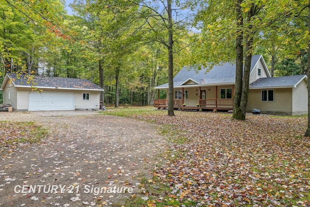 view of front of property featuring a porch, a garage, and an outdoor structure