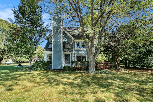 view of front of home featuring a deck and a front lawn