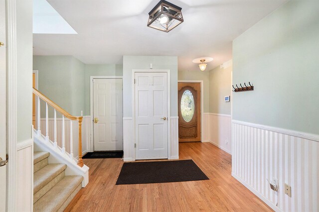 507 Lena Dr, South Haven, MI 49090 - entrance foyer featuring a wainscoted wall, wood finished floors, and stairway
