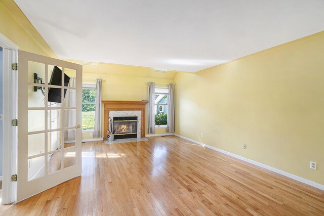 507 Lena Dr, South Haven, MI 49090 - unfurnished living room featuring light wood finished floors, a high end fireplace, and baseboards