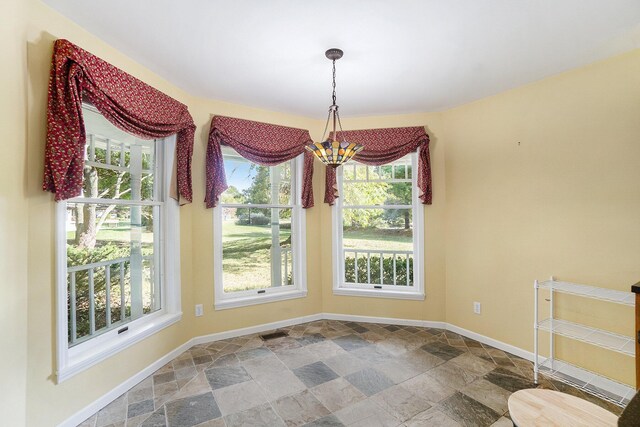 507 Lena Dr, South Haven, MI 49090 - unfurnished dining area with stone finish flooring, plenty of natural light, and baseboards
