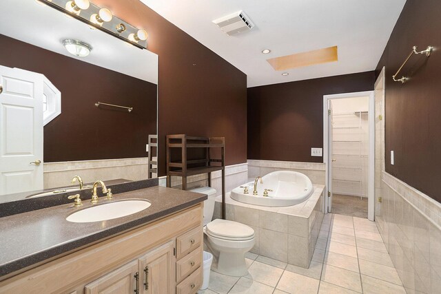 507 Lena Dr, South Haven, MI 49090 - bathroom with a bath, tile patterned floors, vanity, toilet, and wainscoting
