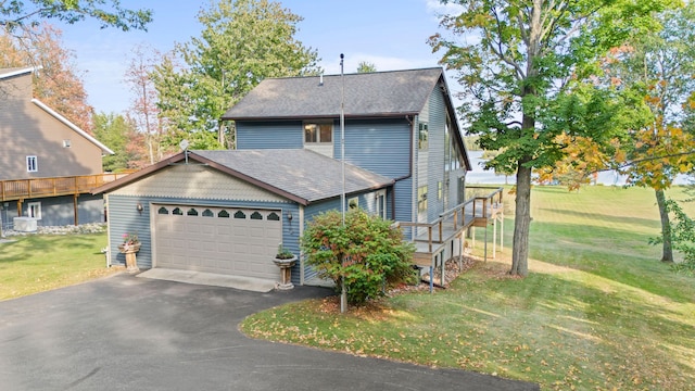 view of front of home featuring a front yard and a garage