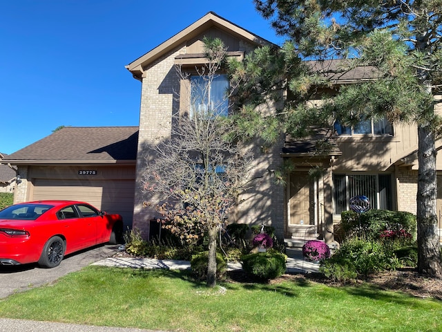 view of front facade with a front yard and a garage