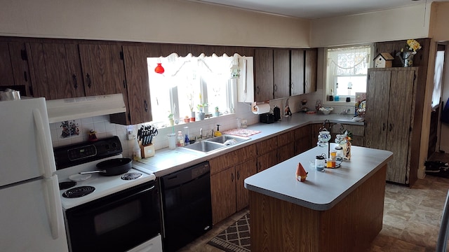 kitchen featuring white appliances, exhaust hood, sink, decorative backsplash, and a kitchen island