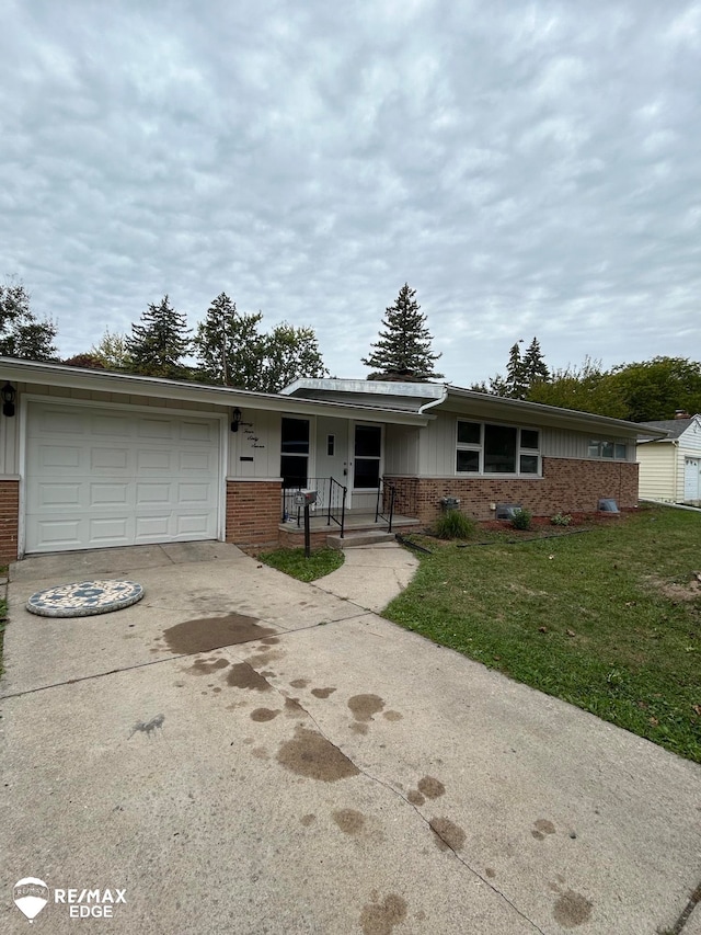 single story home featuring a garage and a front lawn