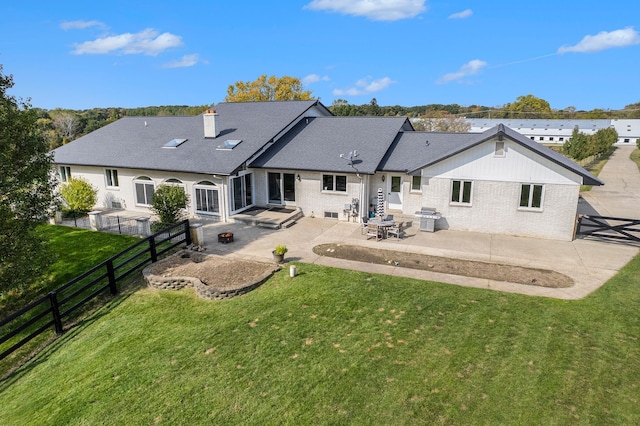 rear view of property with a yard and a patio