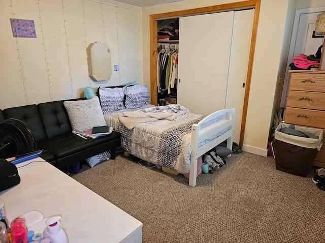 carpeted bedroom with a closet and ornamental molding