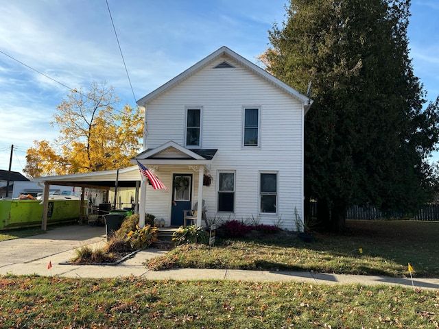 view of front property featuring a front lawn and a carport